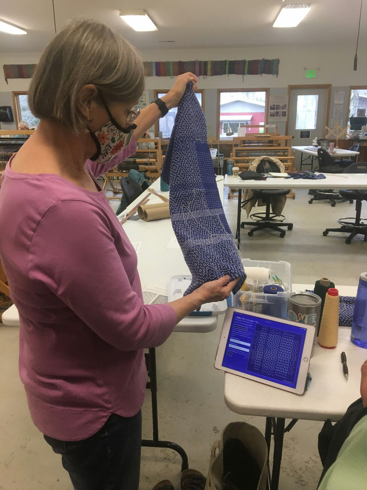Weaving and looking at pattern preview on iPad.